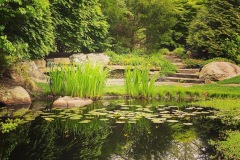 East Hampton, NY -  Man-made pond & waterfall with stone bench, oversized stone pathway, and boulders